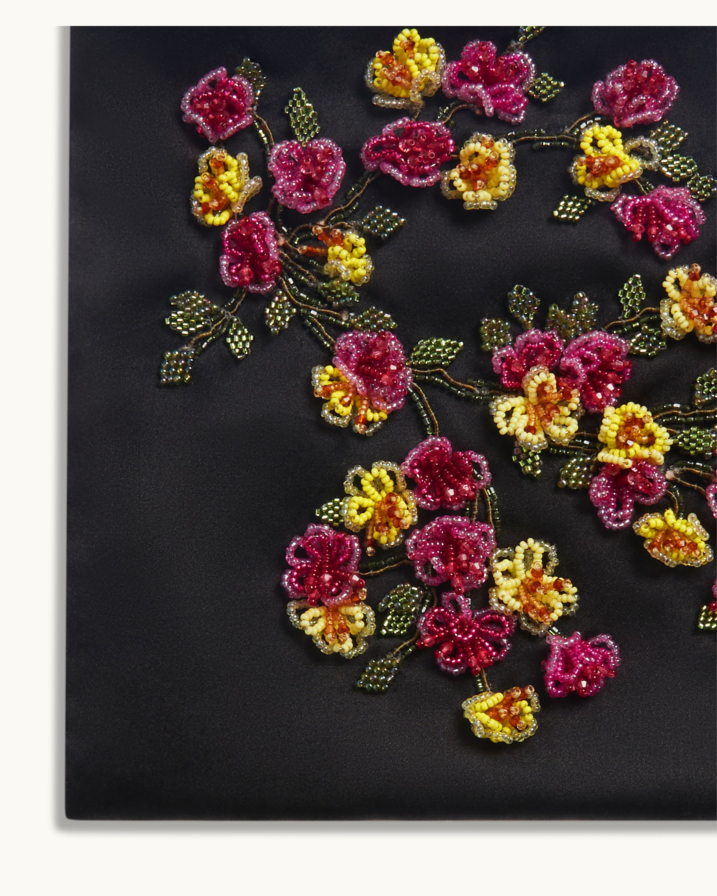 Close-up of hand-beaded floral embroidery on The Veil Pocket Hana Bag in black silk satin