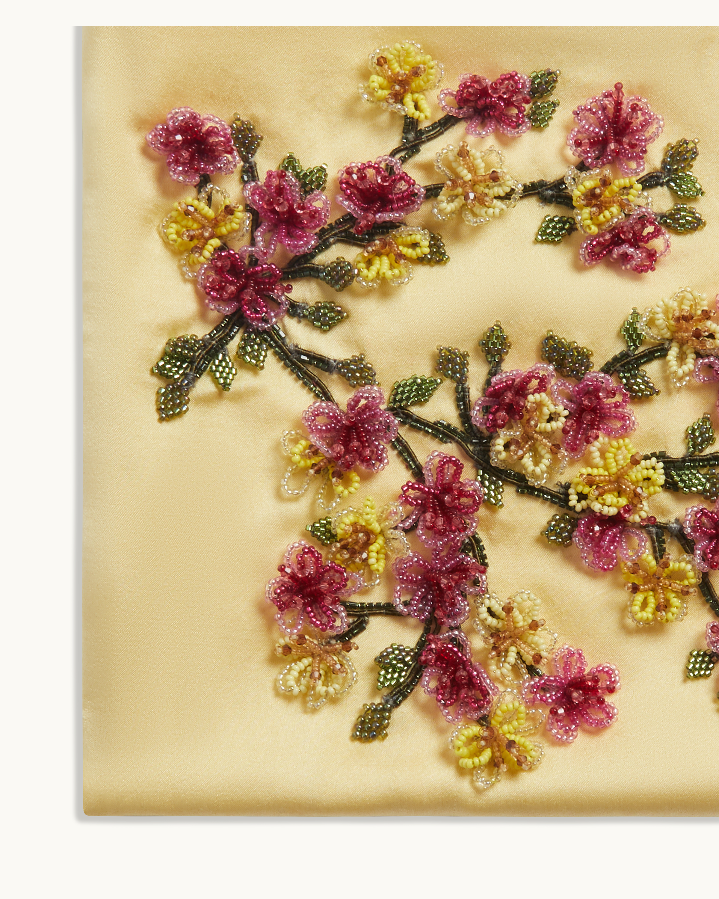 Close-up of hand-beaded floral embroidery on The Veil Pocket Hana Bag in yellow silk satin